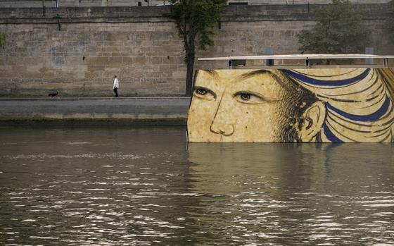 FILE - Reproductions of artworks decorate the banks of the River Seine at the 2024 Summer Olympics, Tuesday, July 30, 2024, in Paris, France. Concerns over water quality in the Seine River resurfaced at the Paralympic Games on Thursday when organizers changed the schedule for para triathlon races. (AP Photo/ Dar Yasin, File)