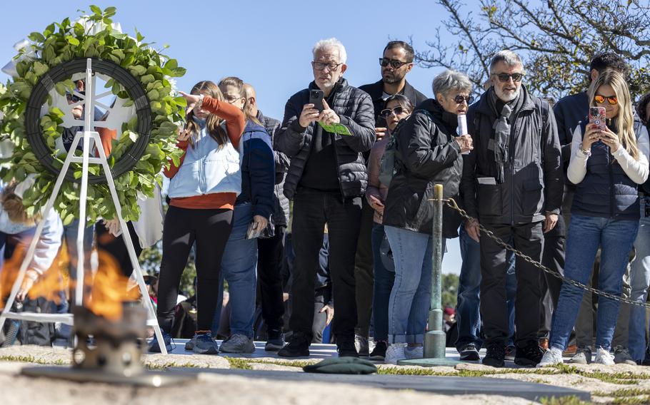 Members of the public photograph the gravesite of President John F. Kennedy, Thursday, Oct. 17, 2024 at Arlington National Cemetery in Arlington, Va.