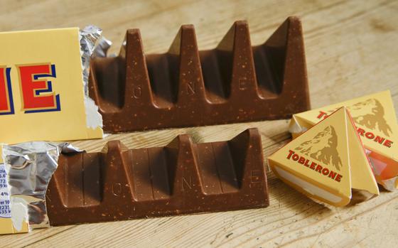 two-bars-of-the-toblerone-swiss-chocolate-are-shown-at-front-is-the-new-style-150-gram-bar