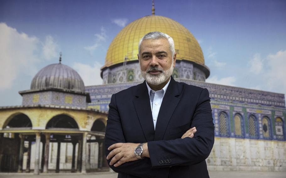 Hamas leader Ismail Haniyeh stands before a giant photograph showing al-Aqsa Mosque in the Old City of Jerusalem, at his home in Gaza City in April 2018. 