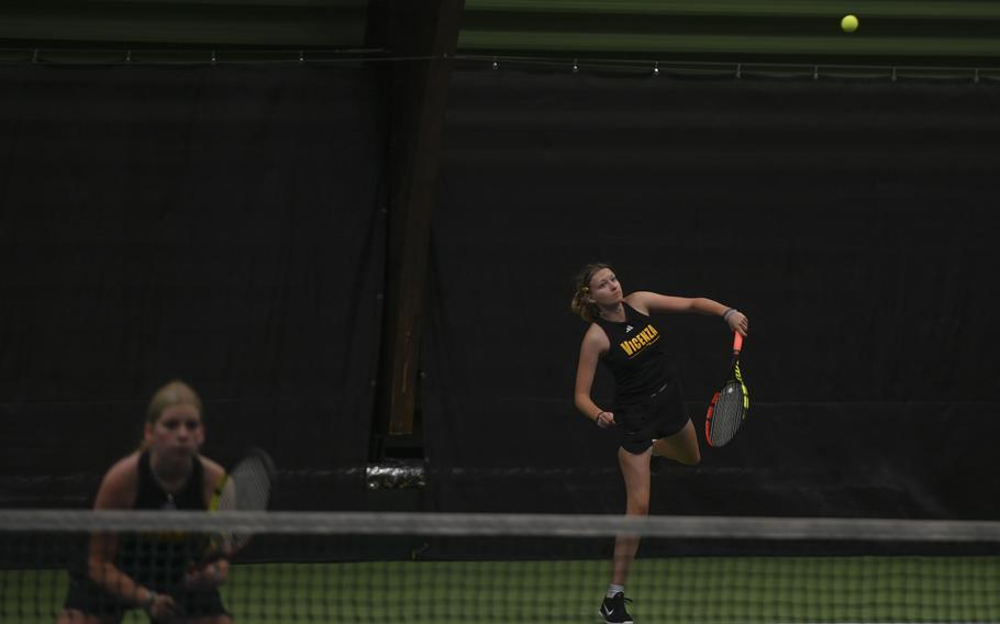 Vicenza's Annika Svenson, right, delivers a sharp serve as her partner Addie Wilson readies herself against Kaiserslautern's Alisa Dietzel and Abby Hover during the DODEA European tennis championships at T2 Sports Health Club in Wiesbaden, Germany, on Oct. 21, 2023.