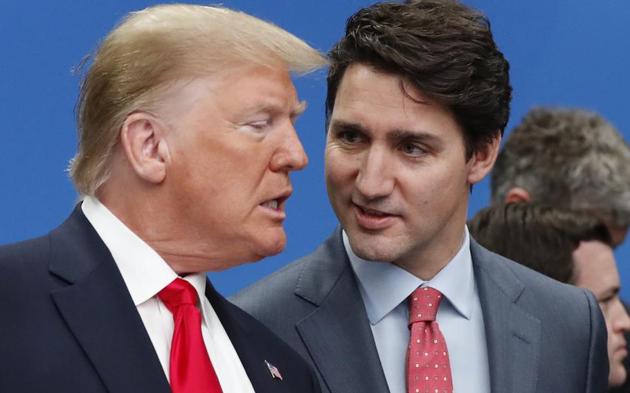 U.S. President Donald Trump, left, and Canadian Prime Minister Justin Trudeau talk prior to a NATO round table meeting at The Grove hotel and resort in Watford, Hertfordshire, England, Dec. 4, 2019. 