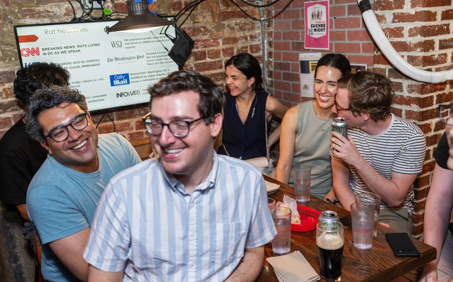 Friends laugh during the “Oh, Rats” presentation given by Washington consultant Seamus O’Neill, 24, at the Tight Five Pub in Adams Morgan.  “It’s nice to take a load off after work,” O’Neill said of PowerPoint parties.  “It’s basically a free comedy show, and maybe you’ll learn something too.”