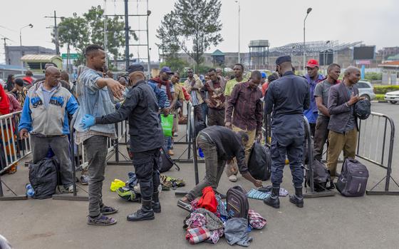 Rwanda security officials check people crossing from Congo in Gyseny, Rwanda, Tuesday, Jan. 28, 2025, following M23 rebels' advances into eastern Congo's capital Goma. (AP Photo/Yuhi Irakiza)