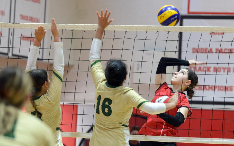 Nile C. Kinnick's Giovanna Kennedy prepares to spike against Robert D. Edgren's Emily Castano and Nalia Najera during the Red Devils' two-set DODEA-Japan victory Saturday.