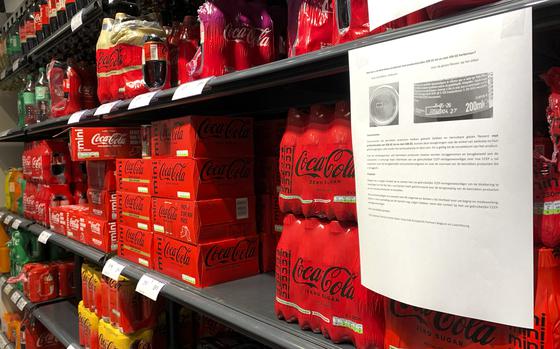 A note is posted next to cleared cases of soft drinks sitting on a shelf in a supermarket in Antwerp, Belgium, after Coca-Cola recalled some of its soft drinks in Europe, Tuesday, Jan. 28, 2025. (AP Photo/Virginia Mayo)