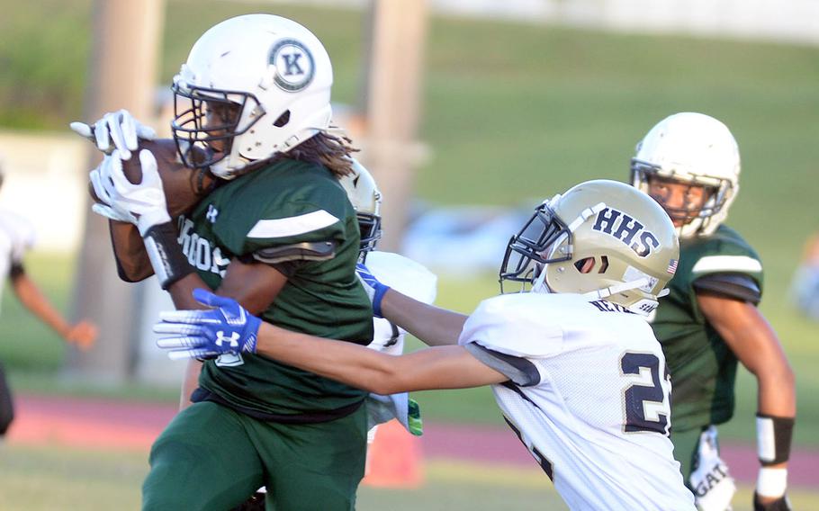 Kubasaki's Carlos Cadet snags a pass in front of Humphreys' Andrew Thompson.