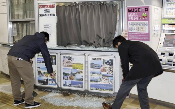 Staff clean up shattered and scattered glass caused by the earthquake at JR Miyazaki Airport Station, in Miyazaki, in southwestern Japan, Monday Jan. 13, 2025. (Kyodo News via AP)