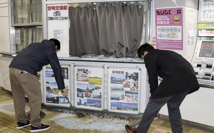 Staff clean up shattered and scattered glass