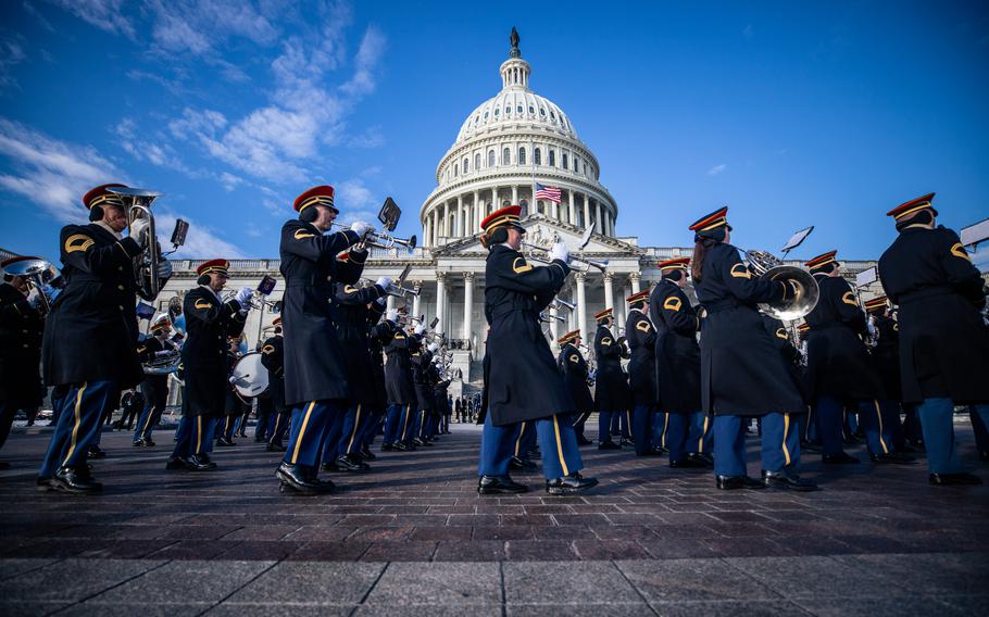 Army band members play their instruments as they march past the Capitol.