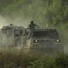 A (MLRS) multiple launch rocket system vehicle comes down the range to empty the rocket pods after a successful firing of the system. 