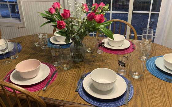 A table that Sarah Bellinger set for a small dinner party with friends on Aug. 25, 2022, in East Hartford, Conn. Bellinger says that throwing her first dinner party was “the most adult thing I did all month.” 