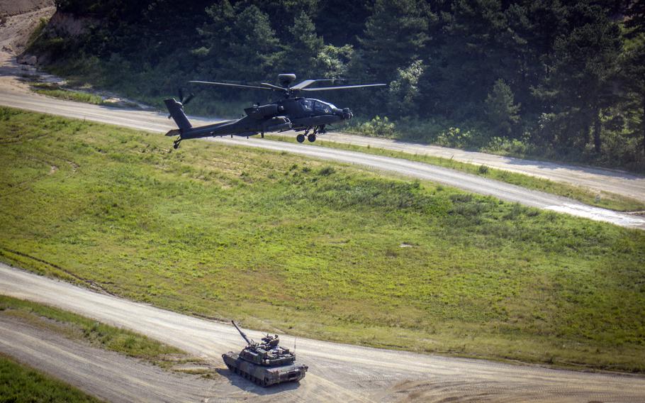 A U.S. Army M1A2 Abrams tank trains alongside an AH-64E Apache helicopter at the Rodriguez Live Fire Complex in Pocheon, South Korea, Aug. 14, 2024. 