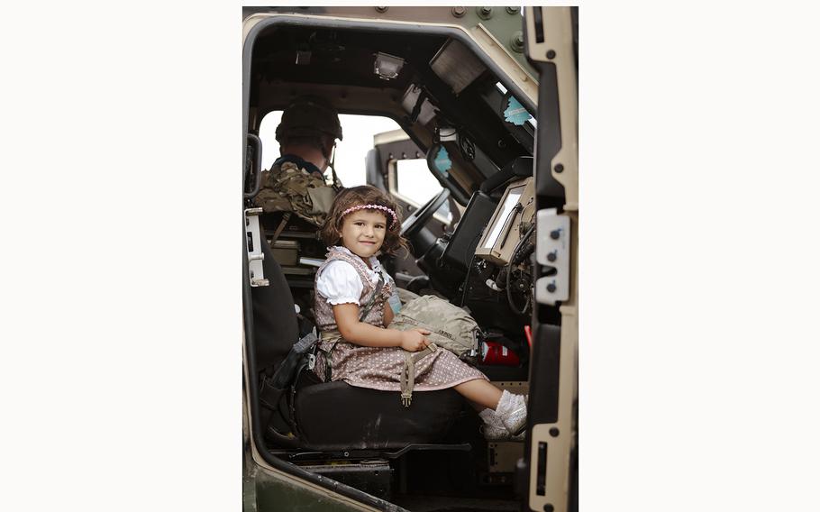 A local family takes a tour of a military vehicle at the 63rd Annual German-American Volksfest on Camp Algiers, Grafenwoehr, Germany from August 2-4, 2024. 