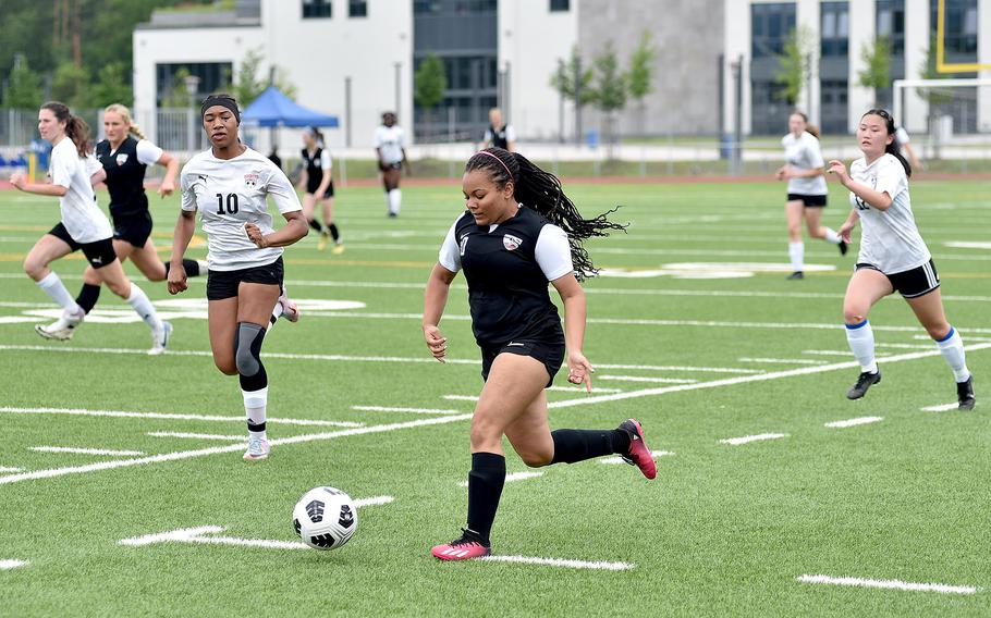 Stuttgart junior Jamilah Ali dribbles along the left wing as Kaiserslautern defenders Jedaiah Quinland, left, and Ava Gin chase during a semifinal match at the DODEA Division I European championships May 22, 2024, at Ramstein High School on Ramstein Air Base, Germany.