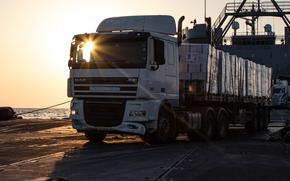 A truck transports humanitarian aid from the U.S.-built pier onto the beach in Gaza on June 22, 2024.