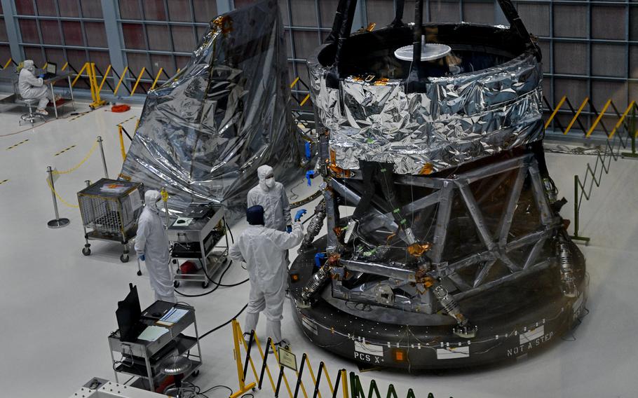 Workers at NASA assemble the telescope.