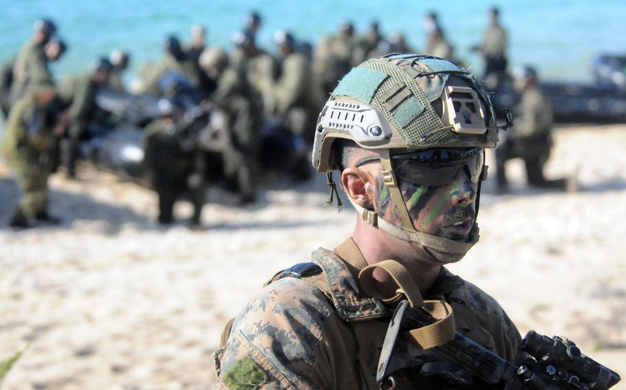 A U.S. Marine takes his position after landing on Kin Blue Beach.