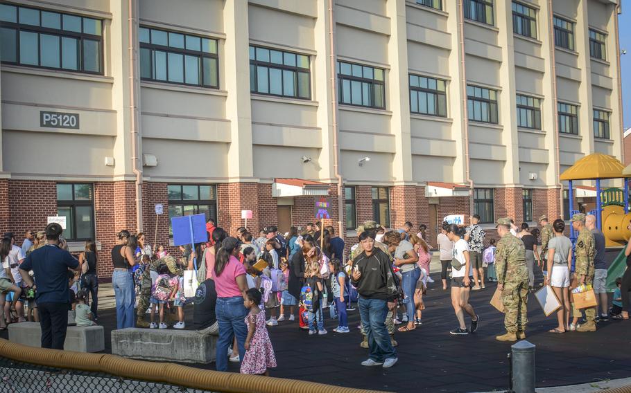 Students and parents arrive for the first day of classes at Humphreys Central Elementary School at Camp Humphreys, South Korea, Monday, Aug. 19, 2024. 