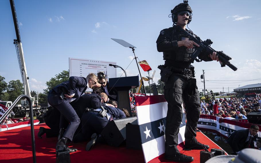 U.S. Secret Service agents and counterassault team react moments after shots were fired toward Republican presidential candidate and former president Donald Trump during a rally in Butler, Pa., on Saturday. 