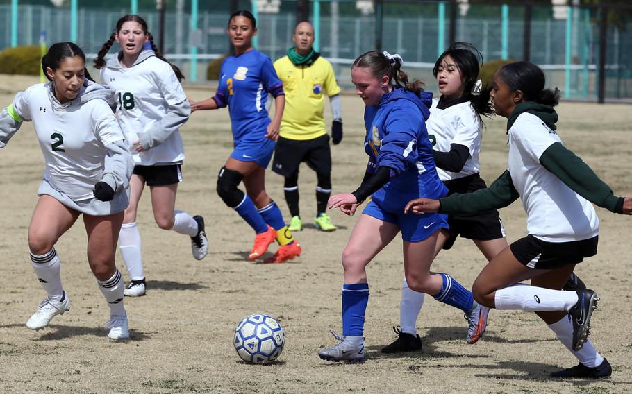 Yokota's Hailey Riddels cuts her way through Robert D. Edgren defenders Aaliyah Torres, Geia Acuzar and Jaeda Stallworth during Saturday's DODEA-Japan girls soccer match. The Panthers won 8-0.