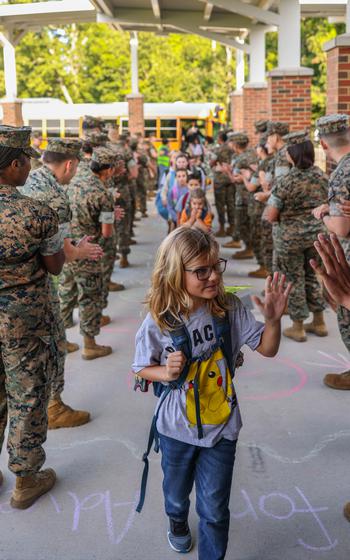 Students are greeted by U.S. Marines during a back-to-school celebration at the Crossroads Elementary School on Marine Corps Base Quantico, Va., Aug. 21, 2024. 