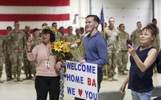 Friends and family members wait to reunite with their Alaska Army National Guardsmen during a welcome home event at the Alaska National Guard Readiness Center on Joint Base Elmendorf-Richardson, Aug. 10, 2024. Approximately 100 Soldiers with Bravo Company, 1st Battalion, 297th Infantry Regiment, returned after a nine-month deployment to Kuwait as part of Operation Spartan Shield. (Alaska National Guard photo by Balinda O’Neal)