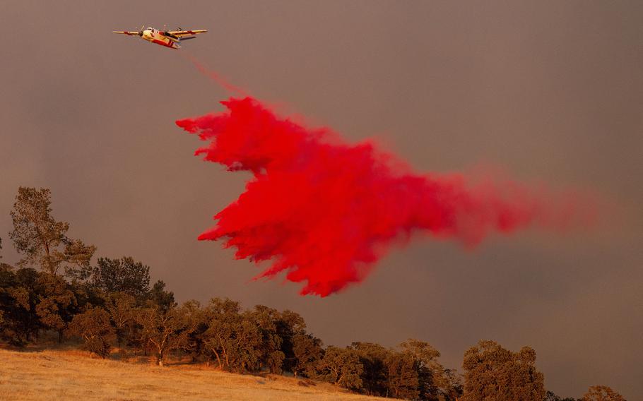 An air tanker drops retardant while battling the Aero Fire in the Copperopolis community of Calaveras County, Calif., Monday, June 17, 2024. 