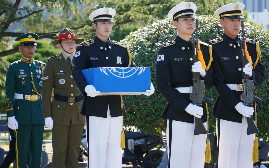 The U.N. Command Honor Guard carries the remains of an unidentified Korean War service member at the U.N. cemetery in Busan, South Korea, Nov. 11, 2024. 