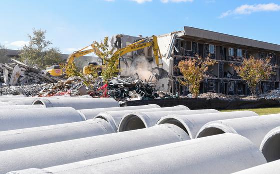 Construction workers demolish a former barracks building on Camp Lejeune, N.C., on Nov. 1, 2023. Dozens of construction projects are under way at the coastal North Carolina Marine base, including some $3.6 billion worth of renovations and new building projects authorized after the catastrophic Hurricane Florence caused major damage to the base in 2018. (Corey Dickstein/Stars and Stripes)