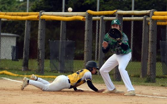 Kadena's Hajime Reed dives back to first base ahead of a pickoff throw to Kubasaki's Jacy Fisk.