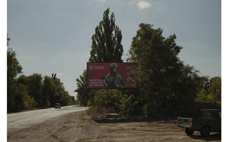 A billboard with a recruitment ad for the Lyut brigade with a photograph of brigade commander Oleksandr Netrebko by a road near Kriviy Rih in the south of Ukraine. 