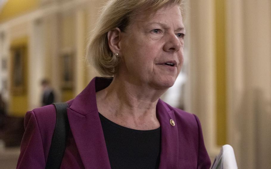 Sen. Tammy Baldwin is seen from the shoulders up, in a magenta suit.