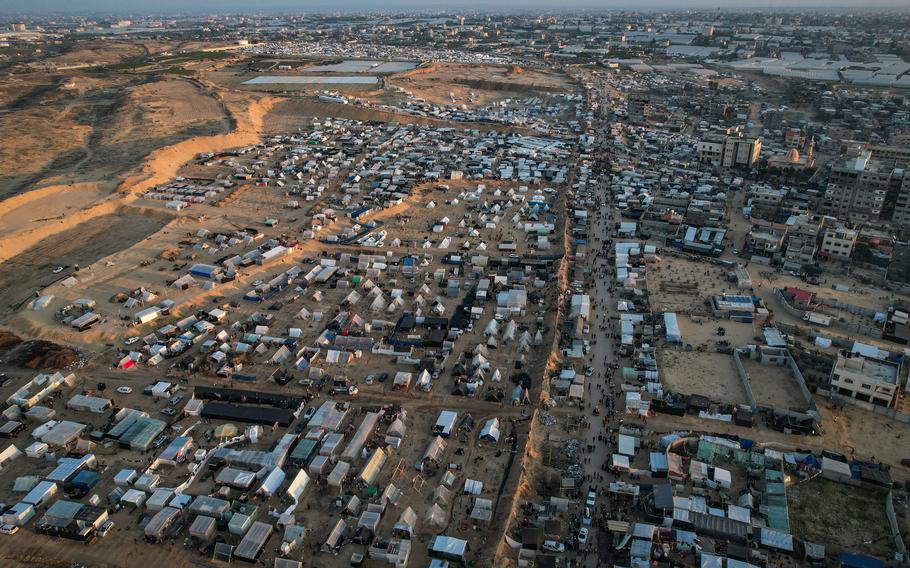 Thousands of Palestinian families take refuge in the UNRWA logistical base and in the temporary tents it built around the warehouse in Rafah, in the southern Gaza Strip, on Monday. 