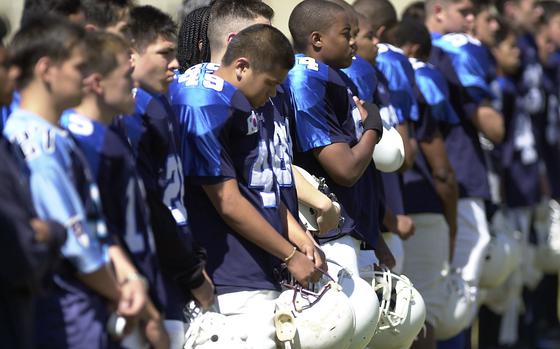 Seoul, South Korea, Sep. 22, 2001: The Yongsan Falcons stand in line to hear the national anthem prior to kick off against the Osan Cougars at Seoul American High School, Seoul Korea.  

META TAGS: National Anthem; DODDS; DODEA: Pacific; football; High school sports; prep