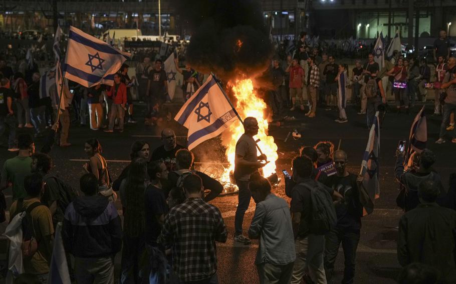 Israelis light a bonfire during a protest in Tel Aviv.