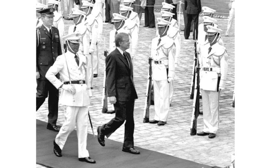 Jimmy Carter in front of an honor guard in Jaan.