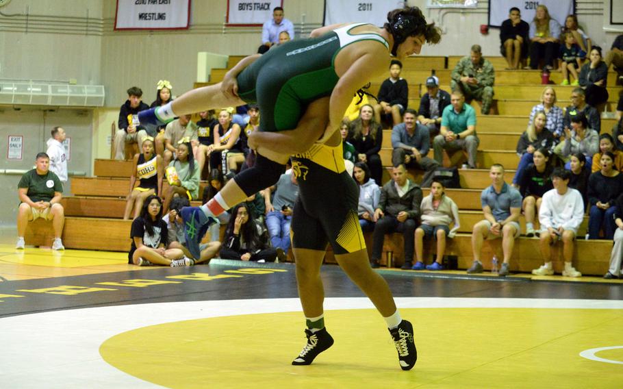 Kadena 215-pounder Jeremiah Drummer sends Kubasaki's Anthony Castle airborne during Wednesday's Okinawa wrestling dual meet. Drummer pinned Castle in 53 seconds and the Panthers won the meet 40-23, improving to 3-0 over the Dragons this season.