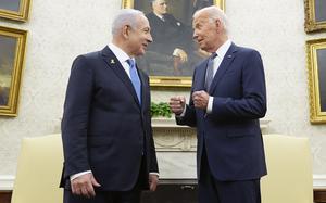 Joe Biden and Benjamin Netanyahu speak in front of portraits of former U.S. presidents in the Oval Office of the White House.