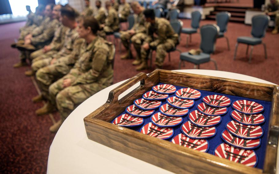 Soldiers assigned to U.S. Forces Japan wait to receive new patches during a ceremony in the Officers' Club at Yokota Air Base, Japan, May 20, 2024.