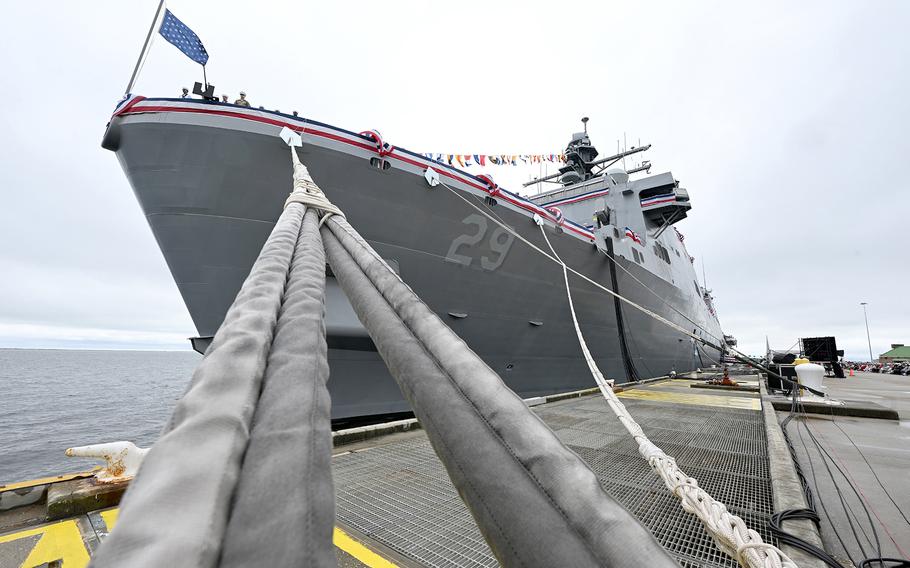 Photo looking up at the bow of a ship that is docked.