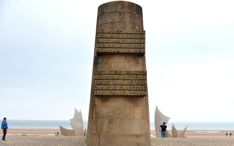 The Signal Monument at Saint-Laurent-sur-Mer on Omaha Beach has a dedication to the 1st Infantry Division on one side and the 116th Infantry Regimental Combat Team on the other. Behind it on the beach is the modern stainless steel sculpture “Les Braves.”