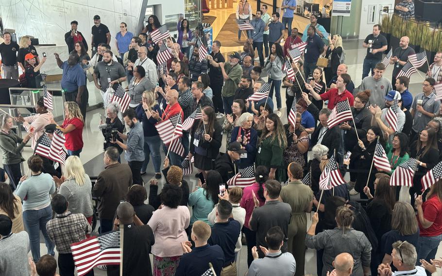 Flags greet World War II veterans at American Airlines headquarters in Dallas-Fort Worth before heading to France for the 80th anniversary commemorations of D-Day in Normandy.