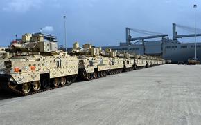 Army M2A3 Bradley Fighting Vehicles sit in a row.