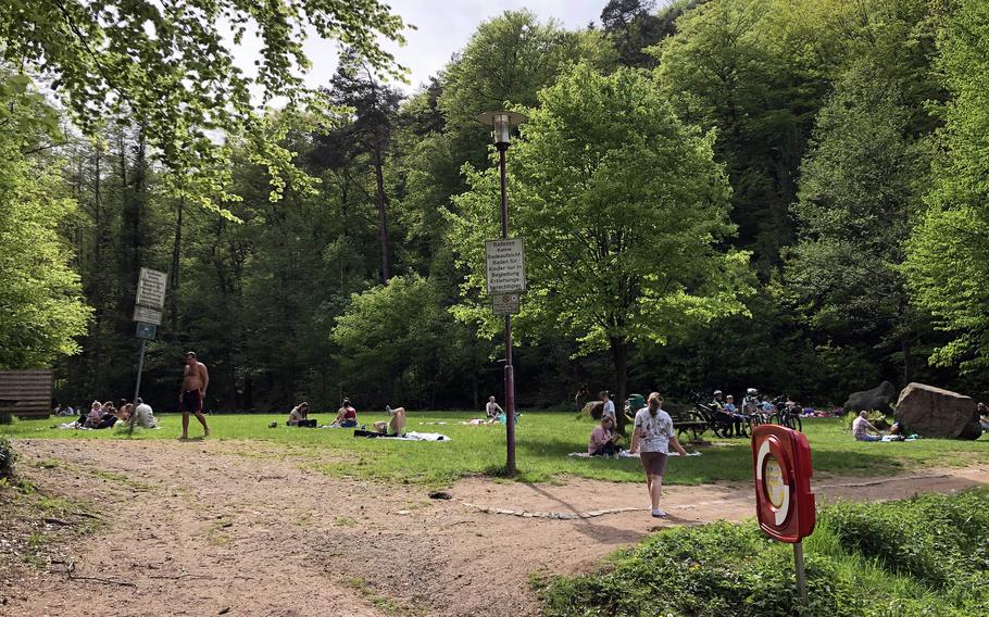 Sunbathers gather on the grass on the south side of Bärenloch in Kindsbach. Germany, on May 1, 2024.