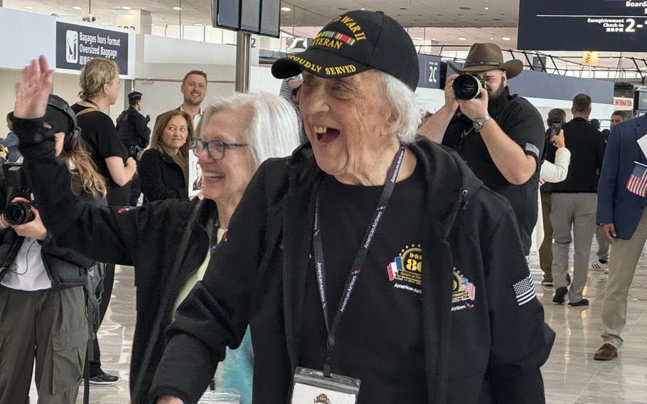 David Yoho, 96, who served aboard an oil tanker in the Merchant Marine in the Pacific in World War II, smiles at well-wishers as he and other veterans arrive in Paris to attend ceremonies marking the 80th anniversary of D-Day. 
