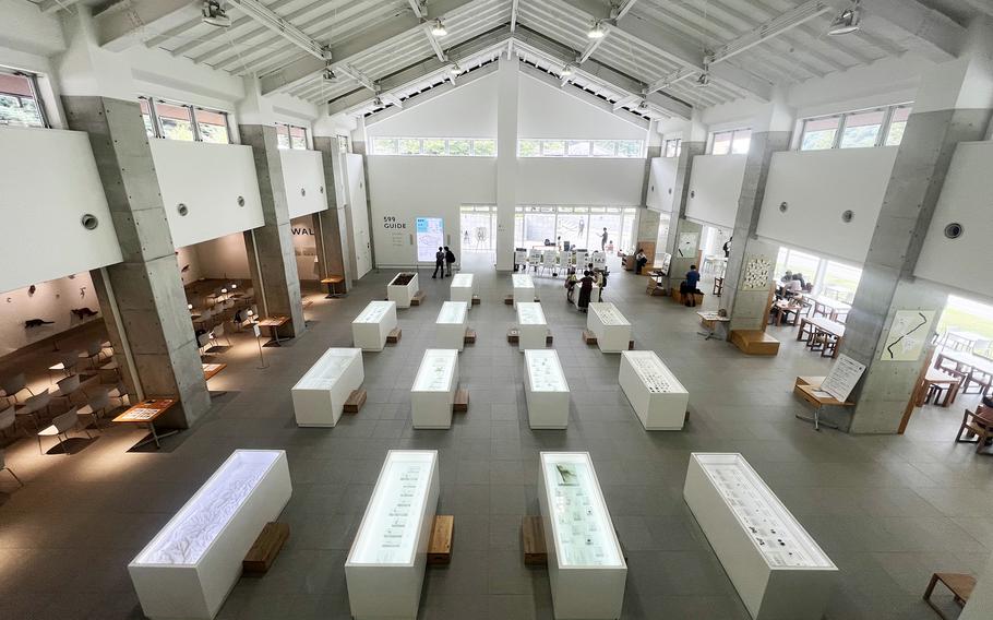 Rows of displays line a high-ceilinged room at the 599 Museum near Mount Takao in Japan.