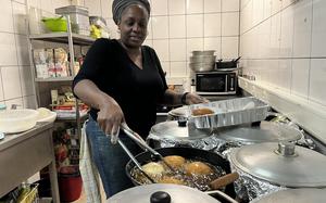 Christine Francis, owner of the Caribbean Grill in Grafenwoehr, Germany, flips her signature stuffed dumplings at the restaurant on Oct. 22, 2024.