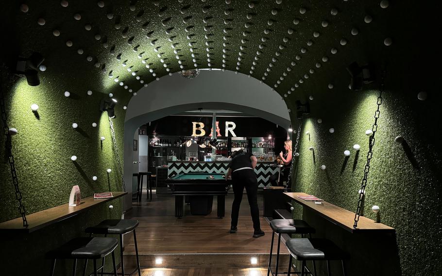 People play pool in a basement bar in Germany.