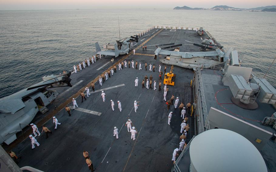 Sailors on the amphibious assault ship USS America and Marines from the 31st Marine Expeditionary Unit prepare to man the rails during a port call at  Busan, South Korea, on Sept. 5, 2024. 